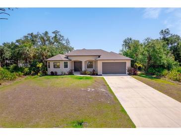 Charming single-story home with a well-manicured lawn and inviting entrance at 172 Berthoud St, Port Charlotte, FL 33953
