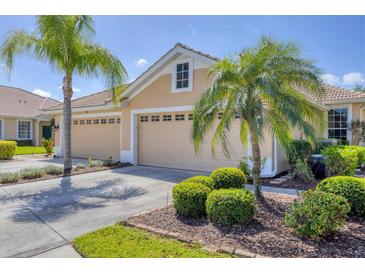 Charming home featuring a three-car garage, tile roof, and well-manicured landscaping with mature palms at 5641 Hidden Oak Ct, North Port, FL 34287