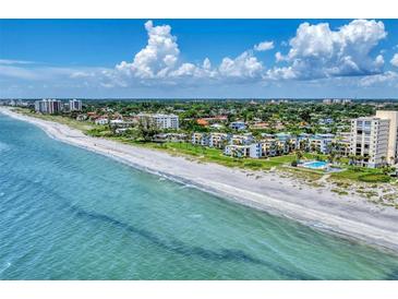 Beautiful coastal condo community with white sand beach and turquoise water, perfect for relaxation at 700 Golden Beach Blvd # 115, Venice, FL 34285