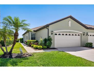 Charming single-story home with a lush lawn, mature landscaping, and a convenient two-car garage at 11343 Bertolini Dr, Venice, FL 34292