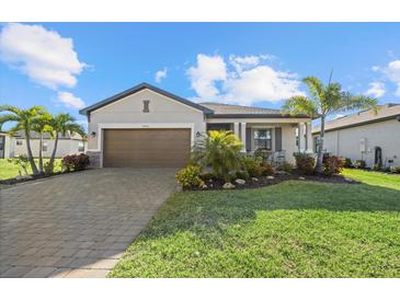 Charming single-story home features a well-manicured lawn and lovely landscaping at 2000 Gardenia Ave, Port Charlotte, FL 33953