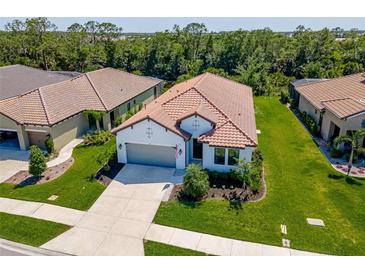 Beautiful aerial view of the charming single-Gathering home with a well-manicured lawn and a tile roof at 264 Caserta Ct, Nokomis, FL 34275