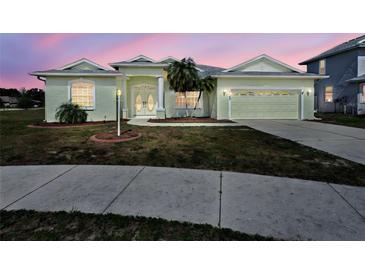 Charming one-story home with a two-car garage, lush landscaping, and a welcoming front entrance at 4062 Green Tree Ave, Sarasota, FL 34233