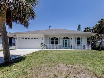 Charming single-story home with white exterior, light blue shutters, and a well-manicured lawn at 5931 Plover Rd, Venice, FL 34293