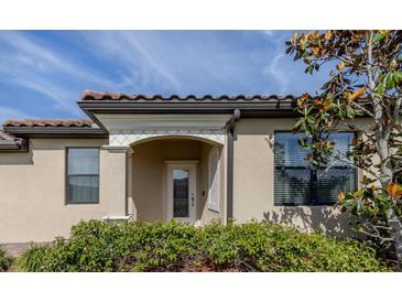 Charming home featuring an inviting front door and decorative accents with well manicured landscaping at 12515 Felice Dr, Venice, FL 34293