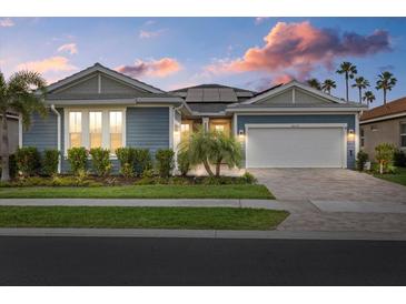 Beautiful single-story home with lush landscaping, a two-car garage, and solar panels, nestled in a vibrant community at 20591 Ovid Ln, Venice, FL 34293