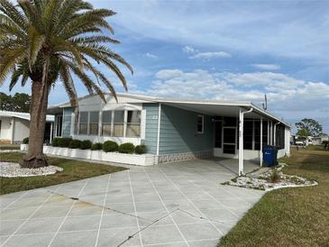 Charming home featuring a well-maintained yard, covered driveway, and appealing curb appeal at 22 Nautical Dr, North Port, FL 34287