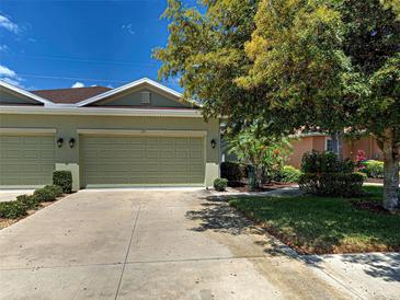 Charming home featuring an attached two-car garage, lovely landscaping, and a well-manicured lawn at 275 Capulet Dr, Venice, FL 34292