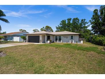 Charming single-story home features a well-maintained lawn, neutral paint, and an attached two-car garage at 3355 Roslyn Rd, Venice, FL 34293