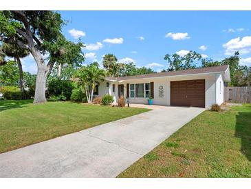Charming one-story home featuring a well-manicured lawn and an attached two-car garage at 348 Dorchester Dr, Venice, FL 34293