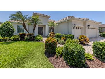 Beautiful landscaping with mature palms enhances this home's curb appeal at 353 Marsh Creek Rd, Venice, FL 34292