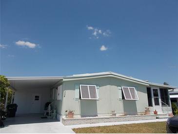 Charming single-story home with well-maintained lawn and covered carport at 358 Longwood Dr, Venice, FL 34285