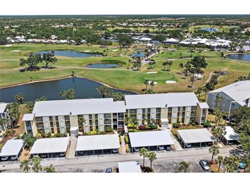 Stunning aerial view of condo community overlooking lush golf course with serene lakes and verdant landscaping at 406 Cerromar N Cir # 128, Venice, FL 34293
