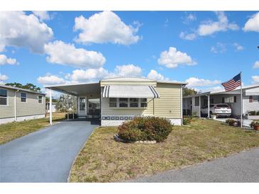 Charming single-story home with a carport and well-maintained landscaping in a quiet neighborhood at 6451 Keena Ct, North Port, FL 34287