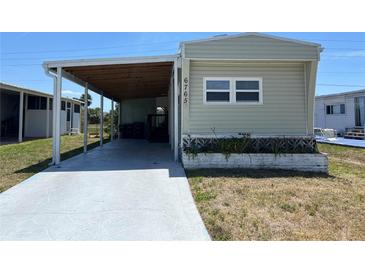 Charming single-story home with covered parking and easy access driveway at 6765 Laurel Ct, North Port, FL 34287