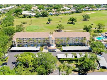 Beautiful condo complex with golf course views, lush landscaping, and convenient covered parking at 1018 Wexford Blvd # 1018, Venice, FL 34293