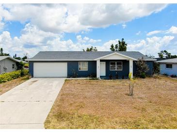 Charming single-story home with a well-maintained lawn and a spacious two-car garage at 144 Rotonda Cir, Rotonda West, FL 33947