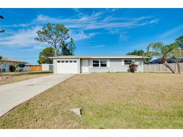 Charming single-story home with a well-manicured lawn and attached garage in a quiet neighborhood at 2980 Siesta Dr, Venice, FL 34293