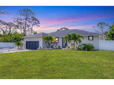 Charming single Gathering home with a well-maintained lawn and tropical landscaping at 307 Bucknell Rd, Venice, FL 34293