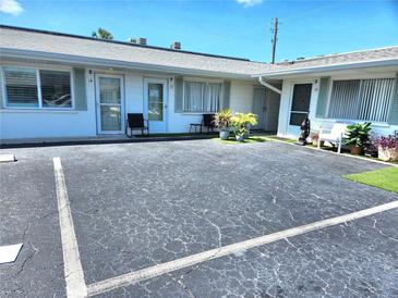 Charming condo exterior with parking and maintained landscaping at 525 Manatee Ct # 13, Venice, FL 34285
