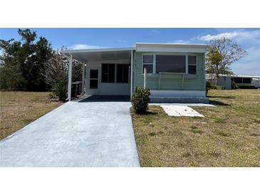 Charming single-story home with a covered patio and a well-maintained lawn at 6741 Laurel Ct, North Port, FL 34287