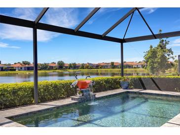 Screened-in pool with water feature and serene lake views, creating a private oasis at 19337 Cruise Dr, Venice, FL 34292