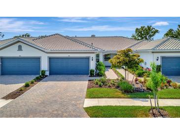 Charming single-story home with well-maintained landscaping and a brick driveway, perfect for easy living at 25069 Pearl Lake Cir, Englewood, FL 34223