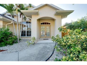 Charming home with a welcoming front entrance, complemented by lush landscaping and a well-maintained walkway at 429 Riviera St, Venice, FL 34285