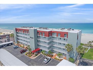 A beautiful high rise condo building with beach front views and a parking area at 950 Tarpon Center Dr # 504, Venice, FL 34285