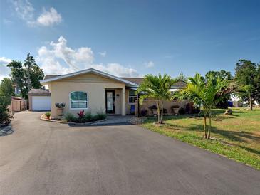 Charming single-story home with a well-manicured lawn and circular driveway at 971 Leeward Rd, Venice, FL 34293