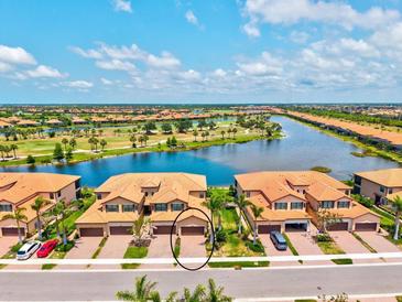 Beautiful aerial view of a townhome community with lake and golf course views at 10808 Tarflower Dr # 102, Venice, FL 34293