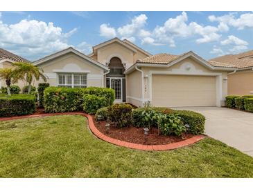 Charming single-story home with manicured landscaping and a two-car garage at 143 Braemar Ave, Venice, FL 34293
