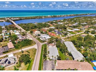 Beautiful aerial view of coastal neighborhood featuring waterfront homes and vibrant blue ocean at 1730 Manasota Beach Rd # 215, Englewood, FL 34223
