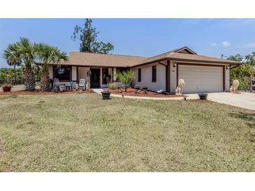 Charming single-story home featuring a 2-car garage, manicured lawn, and inviting front entrance at 2331 Mission Valley Blvd, Nokomis, FL 34275