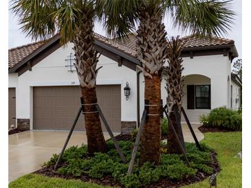 Charming one-story home with well-manicured landscaping and a two-car garage at 249 Tracino Ter, Nokomis, FL 34275