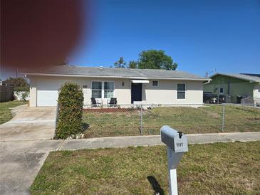 Charming single-story home featuring a well-maintained lawn and inviting front porch seating area at 4149 Gorgas St, North Port, FL 34287