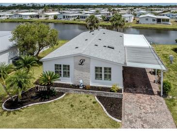 Charming home features a carport, landscaped yard, and canal view at 485 Schooner St, North Port, FL 34287