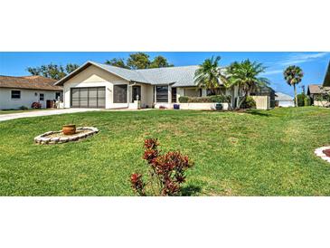 Charming single-story home featuring a well-maintained lawn and mature landscaping in a desirable neighborhood at 5832 Monroe Rd, Venice, FL 34293