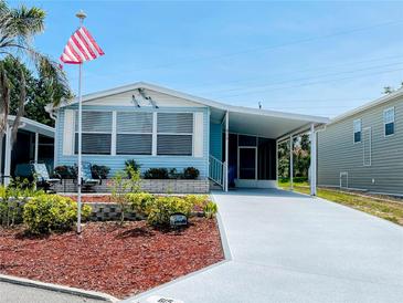 Charming single-story home with well-manicured lawn, covered parking, and cozy patio at 615 S Green Cir, Venice, FL 34285