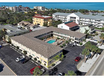 Excellent aerial view of condo complex and sparkling pool with nearby beach and coastal surroundings at 701 Barcelona Ave # 101, Venice, FL 34285
