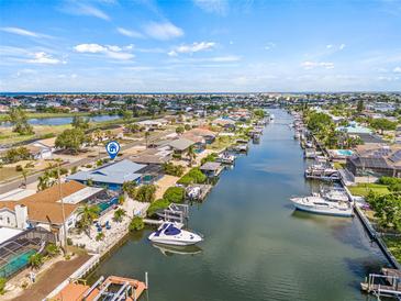 Beautiful waterfront home featuring a private boat dock, boat lift and direct access to the canal at 731 Flamingo Dr, Apollo Beach, FL 33572