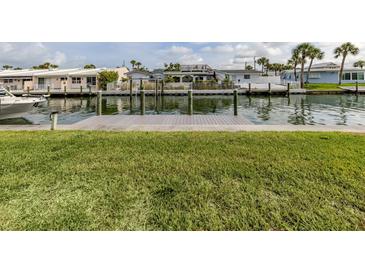Waterfront property featuring a dock and scenic canal views at 832 Whitecap Cir # 5, Venice, FL 34285