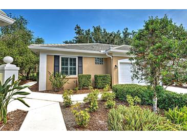 Charming home with a landscaped front yard, walkway and tiled roof at 912 Barclay Ct, Venice, FL 34293
