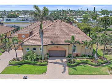 Elegant home showcasing a terracotta roof, well manicured landscaping, and a paver driveway at 9220 43Rd W Ter, Bradenton, FL 34209