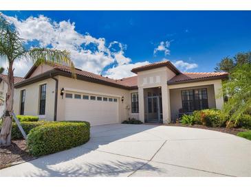 Charming single-story home featuring a terracotta roof, two-car garage and lush landscaping at 1438 Maseno Dr, Venice, FL 34292