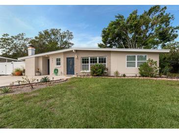 Charming single-story home with a well-maintained lawn and inviting blue front door at 161 Suntan Ave, Sarasota, FL 34237