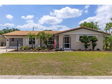 Charming single-story home featuring a well-manicured lawn and a welcoming front entrance at 318 Venice East Blvd, Venice, FL 34293