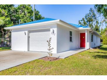 Charming home featuring a bright blue roof, a fresh white exterior, and a striking red front door at 352 Glenwood Ave, Osprey, FL 34229