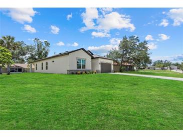 Well-maintained home with a lush green lawn and a view of the neighborhood at 4390 Asteria Ter, North Port, FL 34287