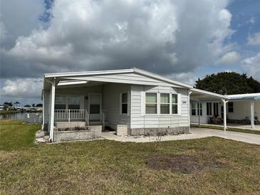 Charming single-story home featuring a covered entrance and a well-maintained front yard at 103 Lakeview Dr, North Port, FL 34287